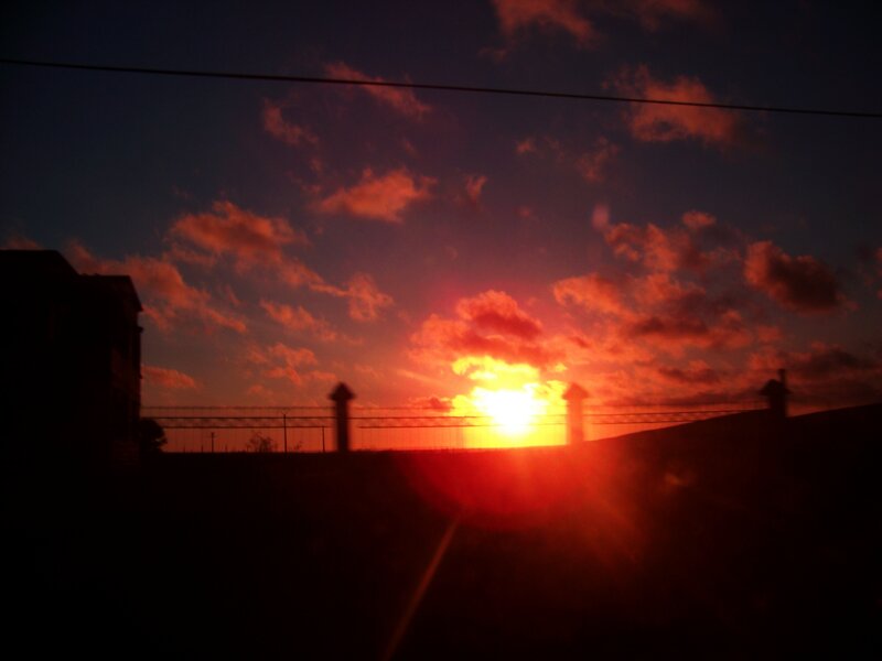 sunset over a fence