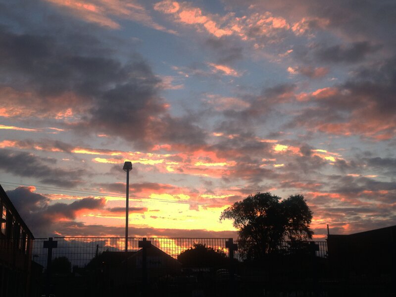 sunset over a fenced area