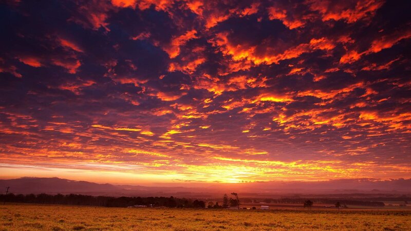 Sunset over a Field — Orange, Dramatic, Photograph, Clouds, Mountains