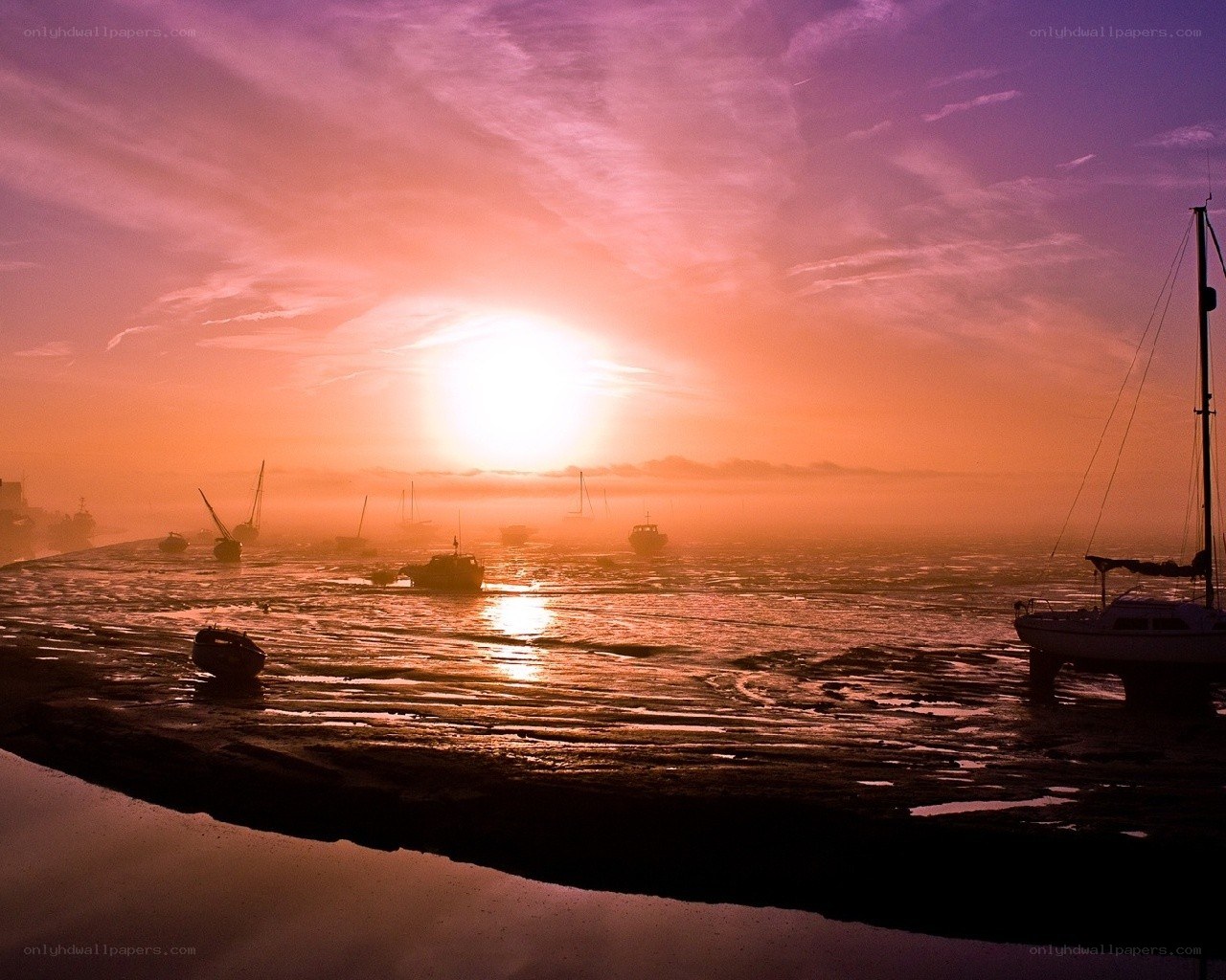 Sunset over a foggy harbor