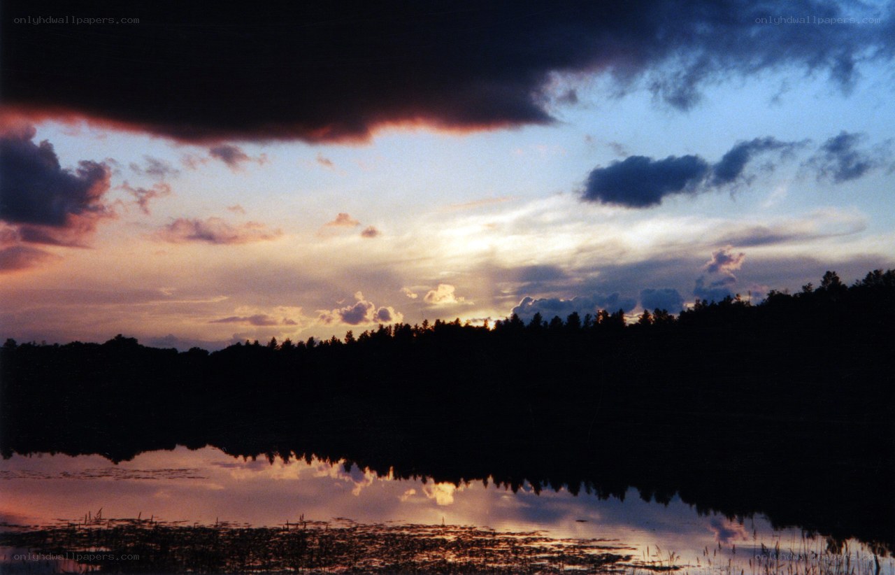 sunset over a forest lake
