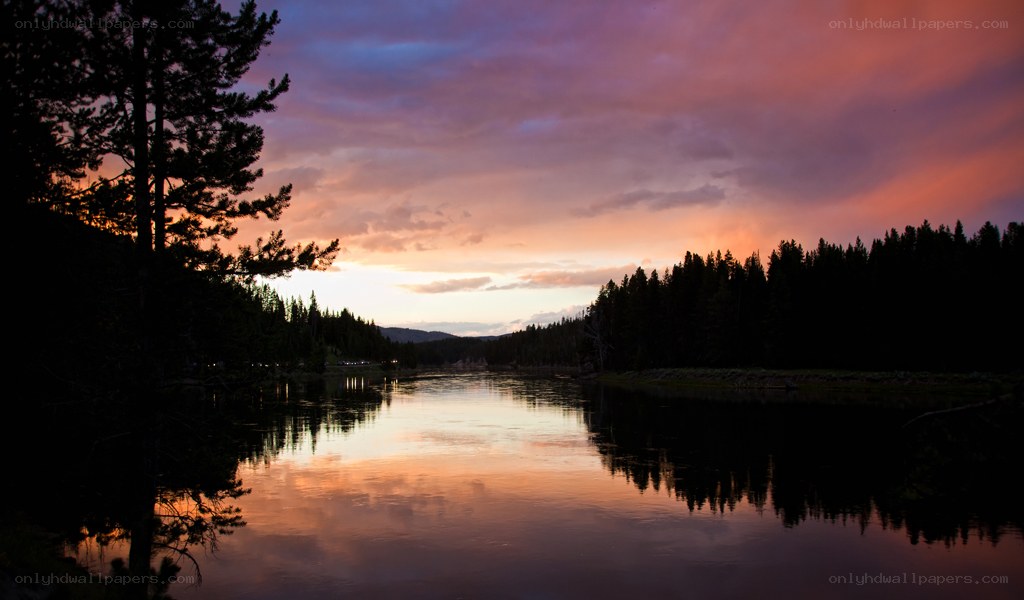 sunset over a forest lake