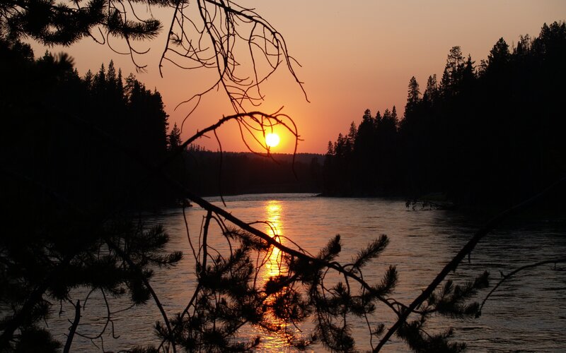 Sunset over a forest river