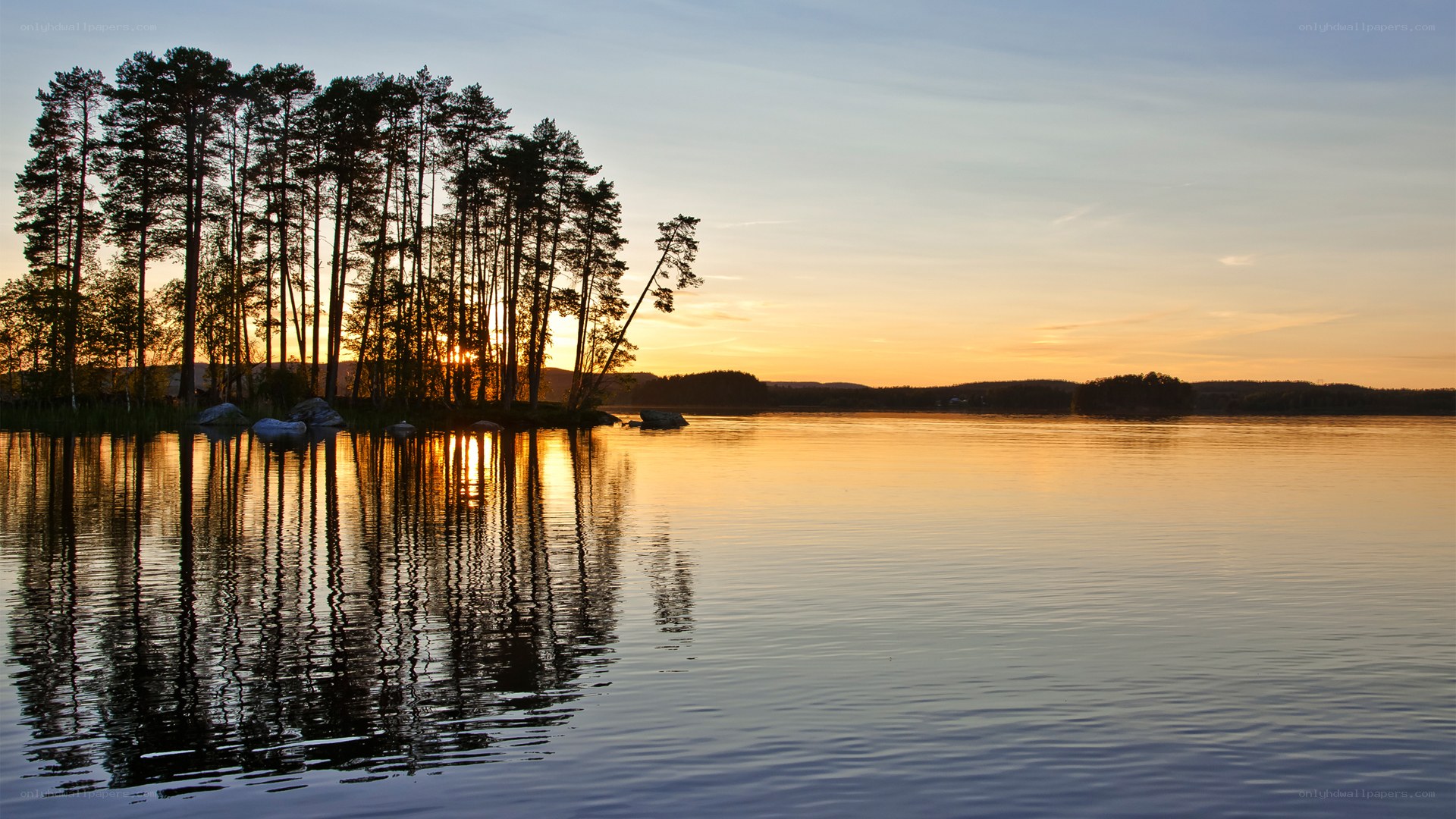 Sunset over a forested lake