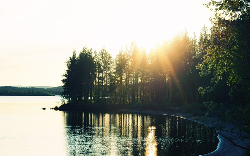 Sunset over a forested lake