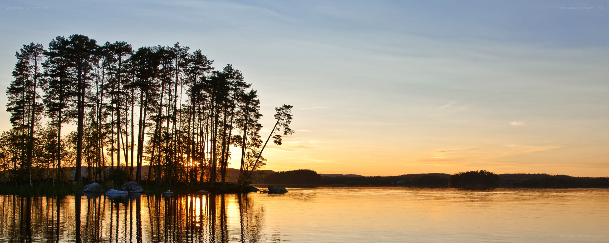 Sunset over a forested lake