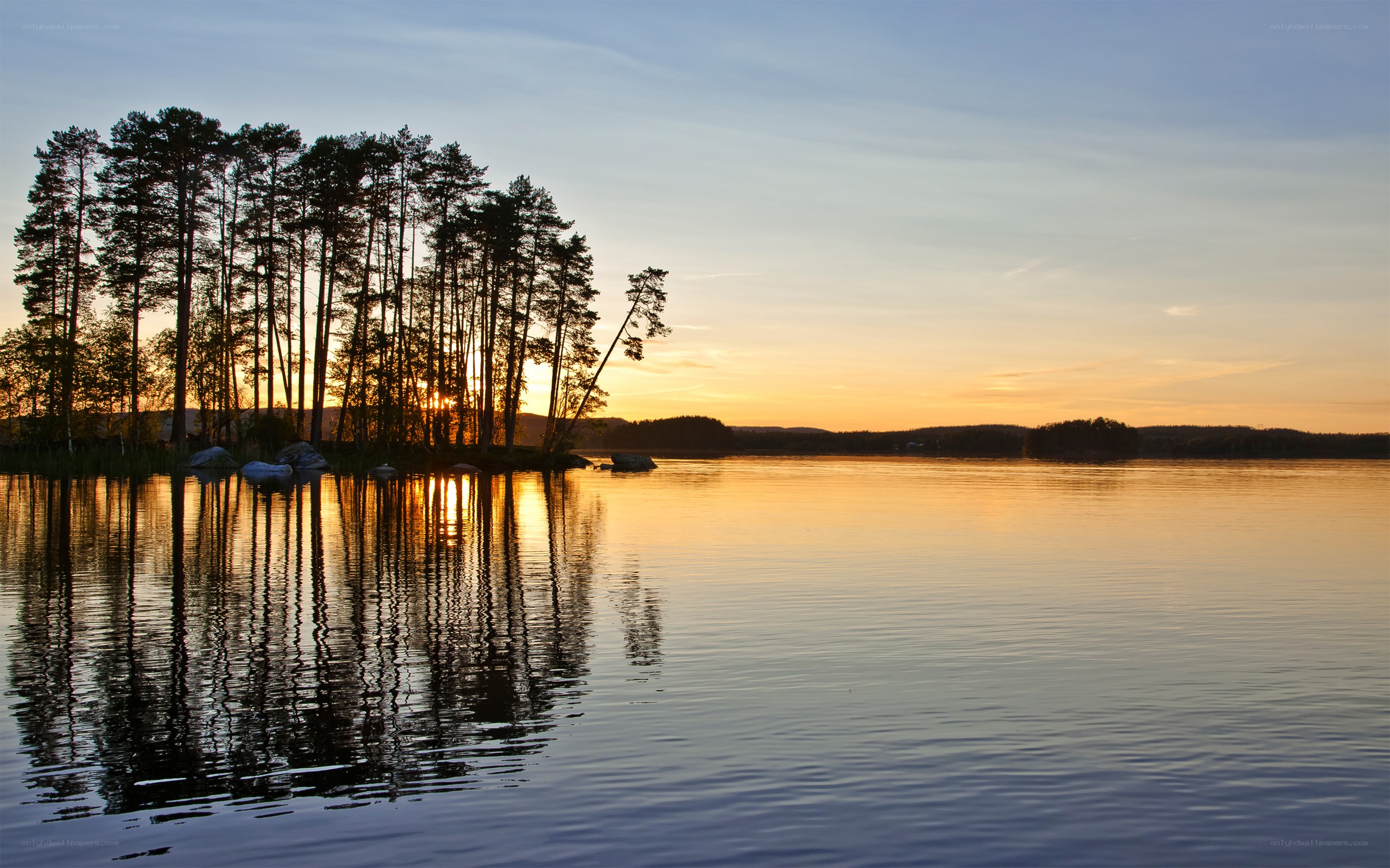 Sunset over a forested lake