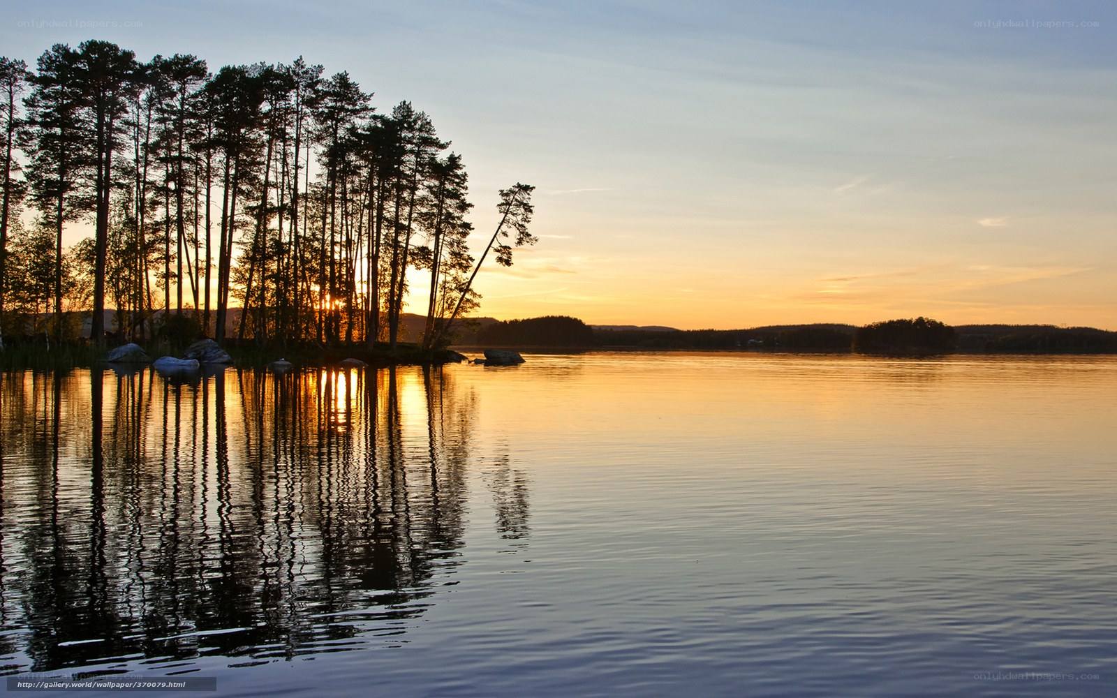 Sunset over a forested lake