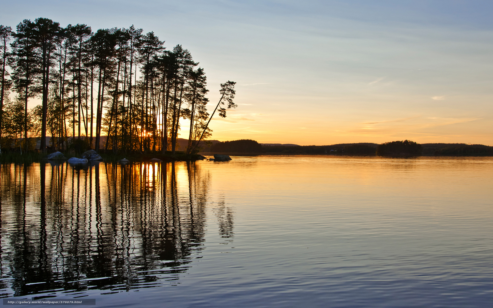 Sunset over a forested lake