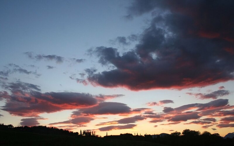 sunset over a forested landscape