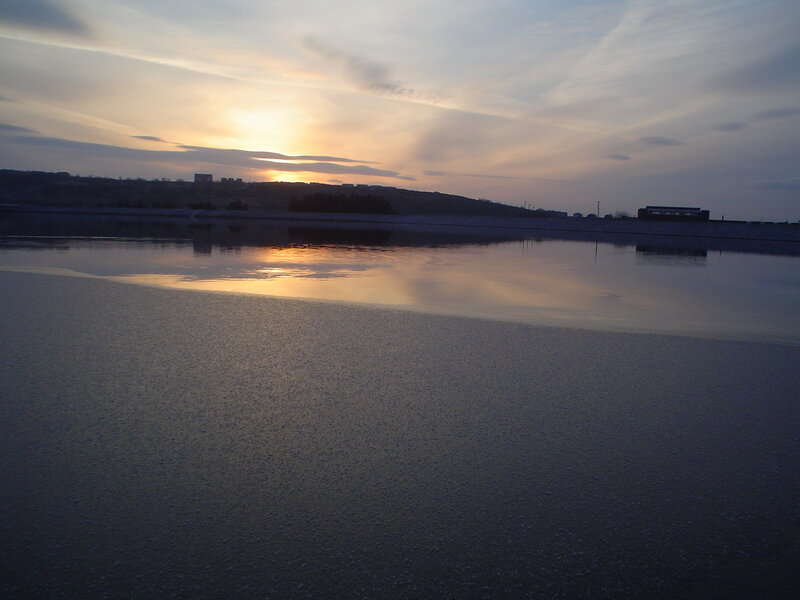sunset over a frozen lake