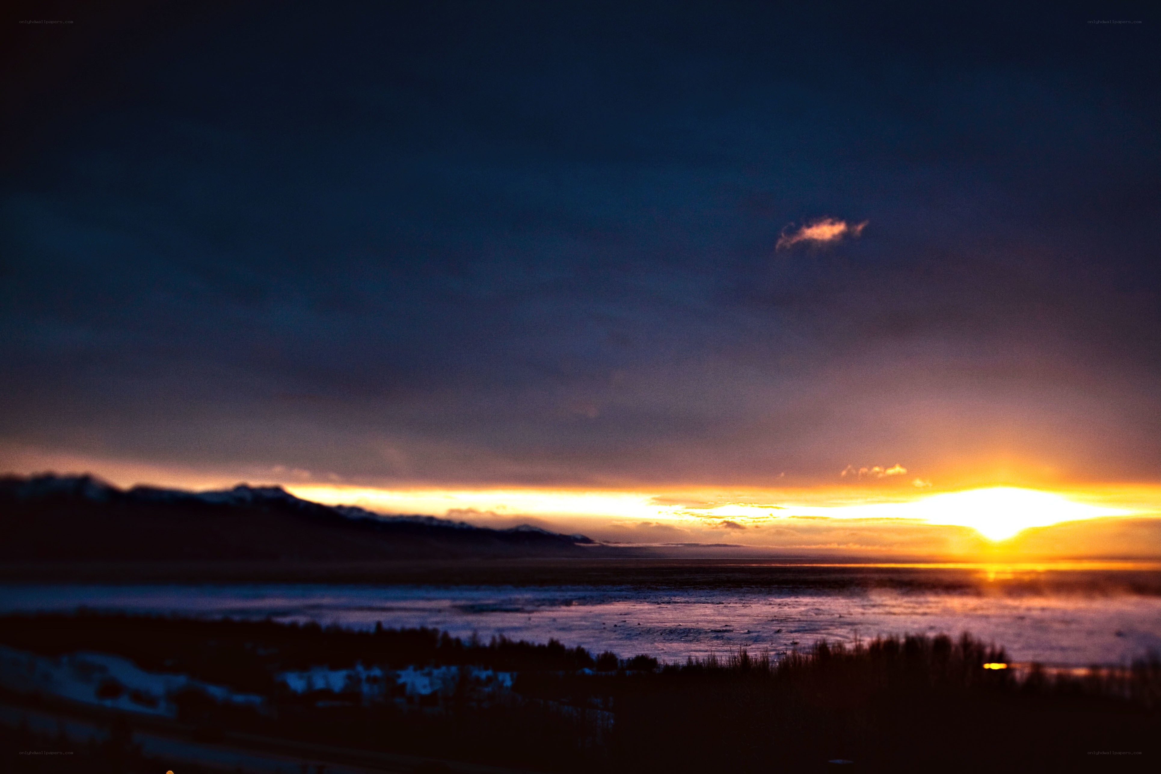 sunset over a frozen landscape