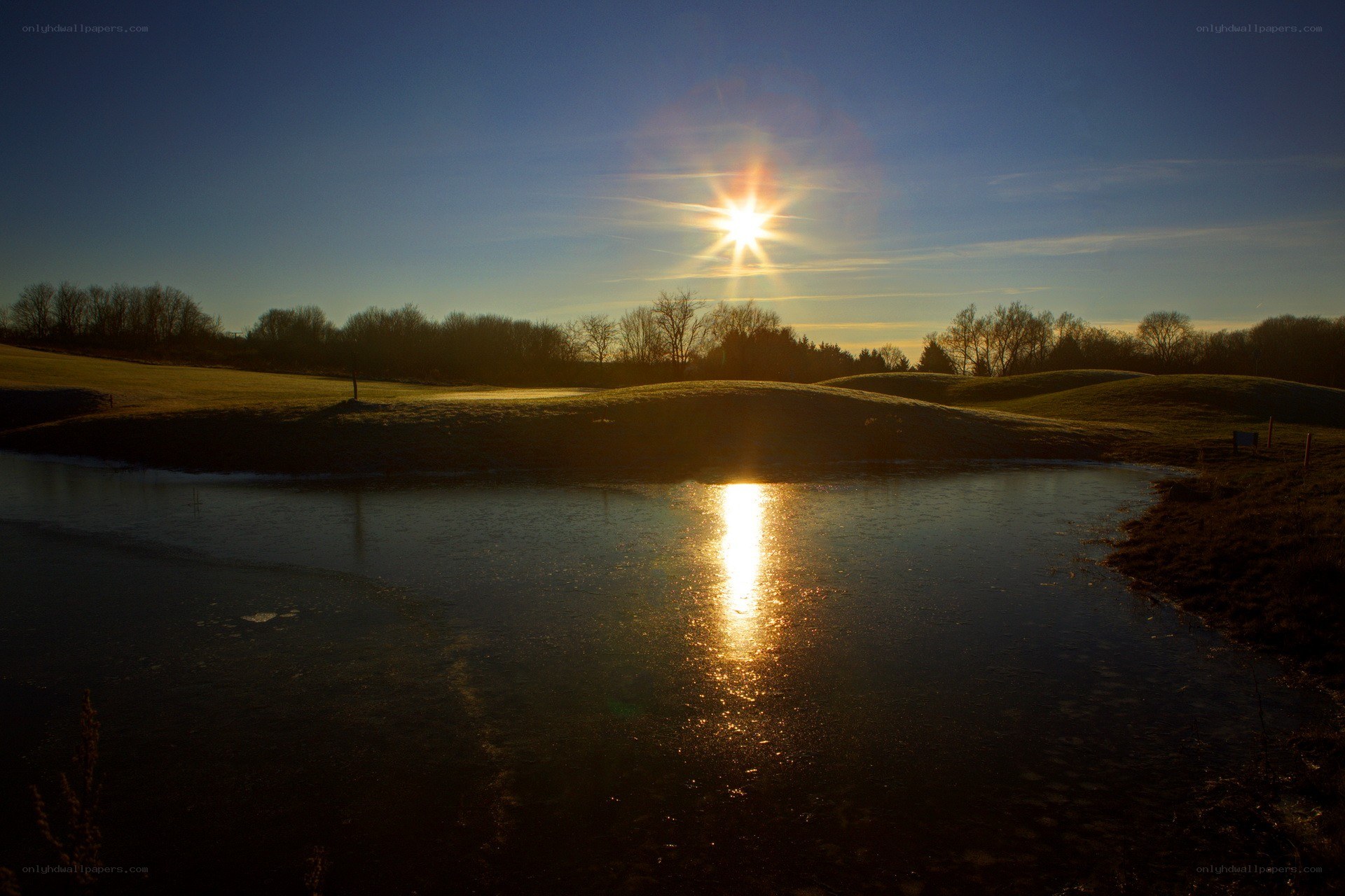 Sunset over a frozen pond