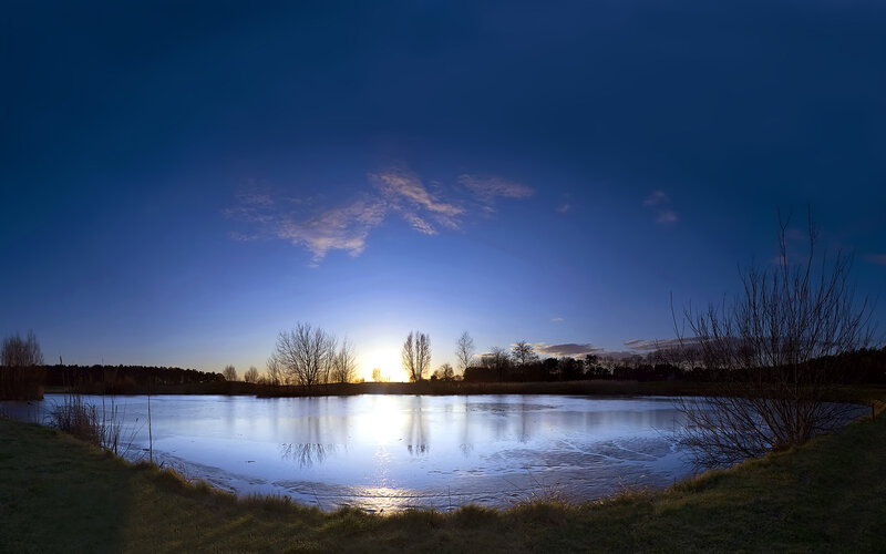 Sunset over a frozen pond