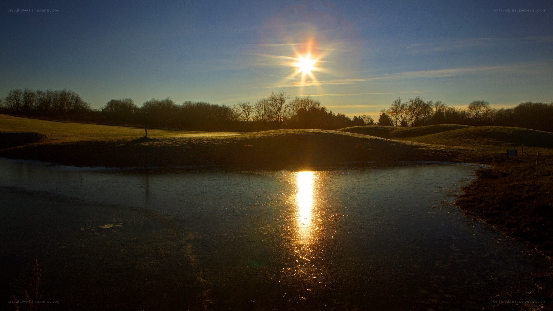 Sunset over a frozen pond