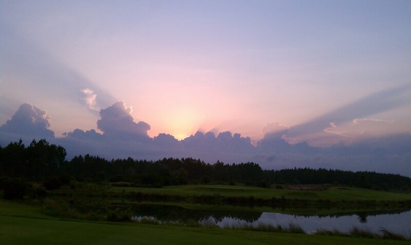 sunset over a golf course