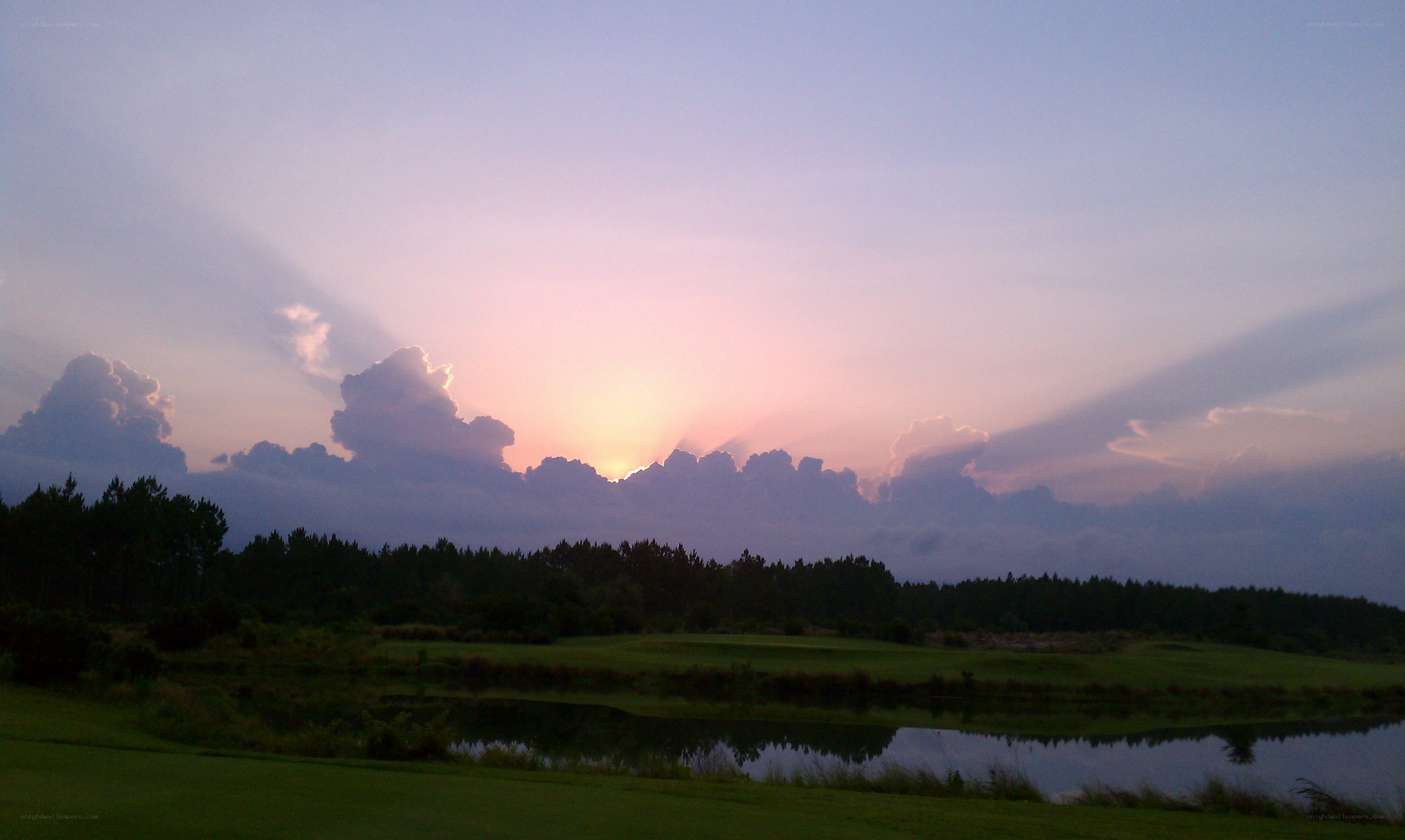sunset over a golf course