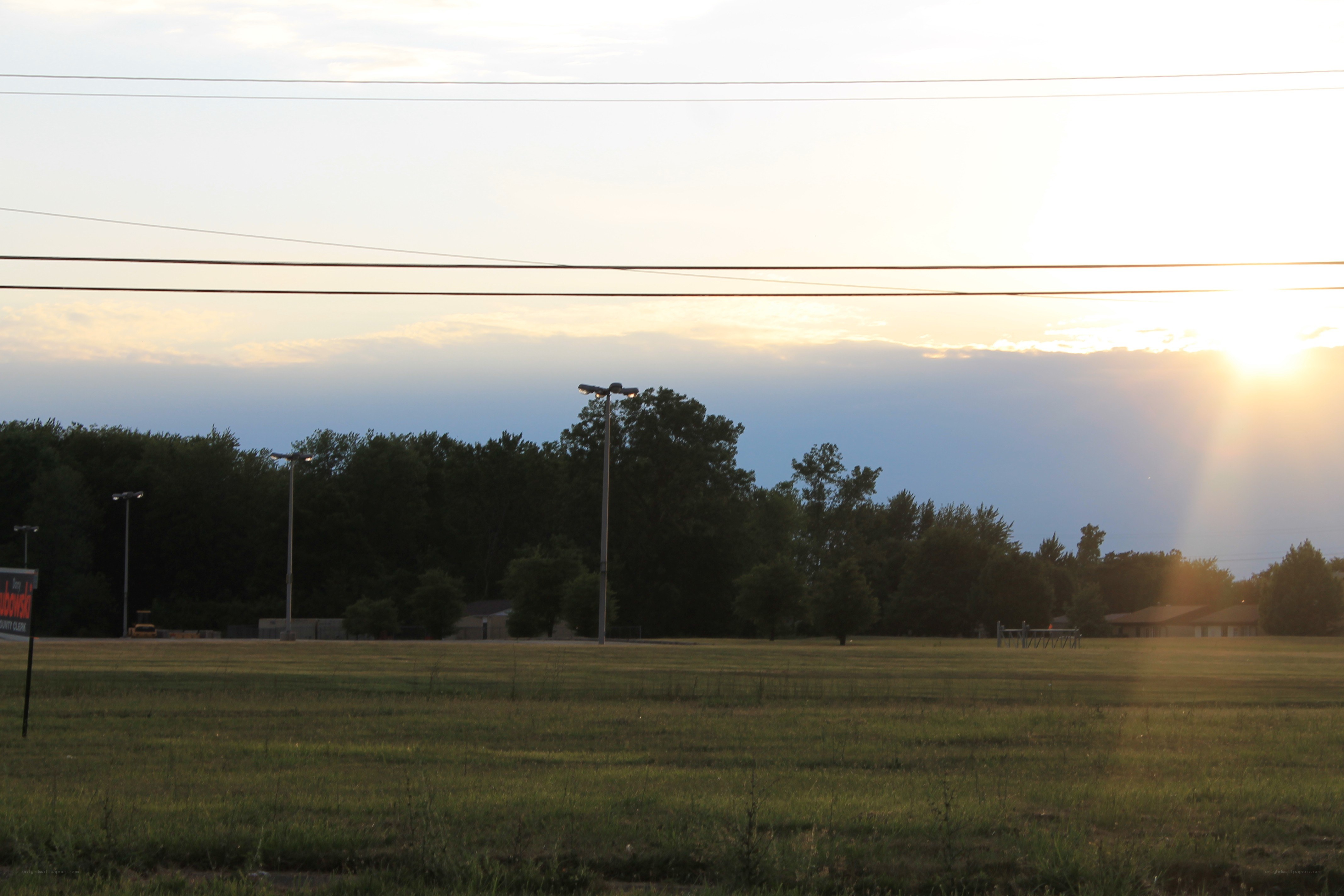 sunset over a grassy field