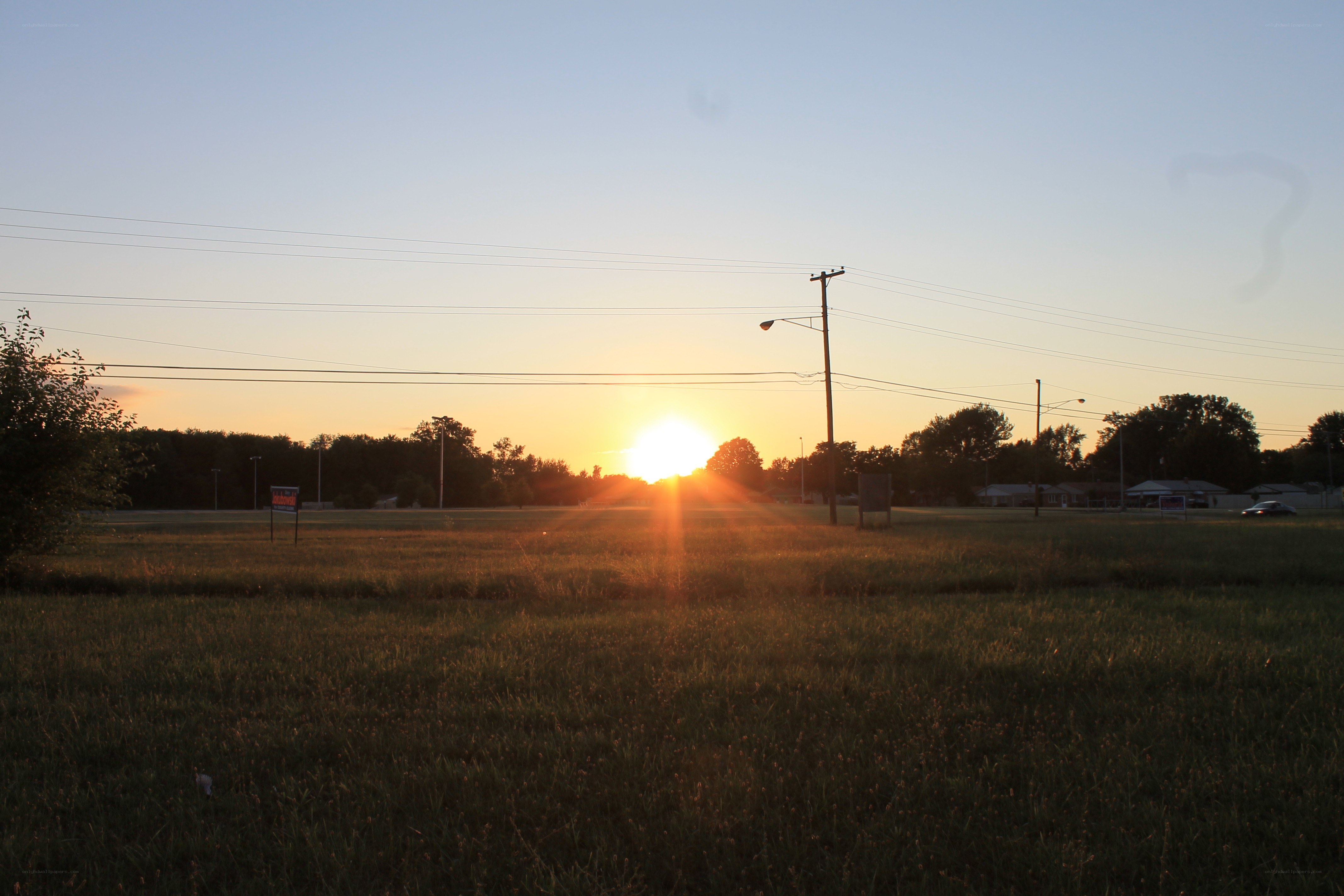 Sunset over a grassy field