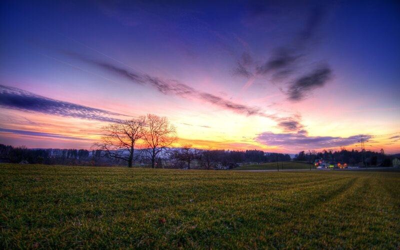 Sunset over a green field