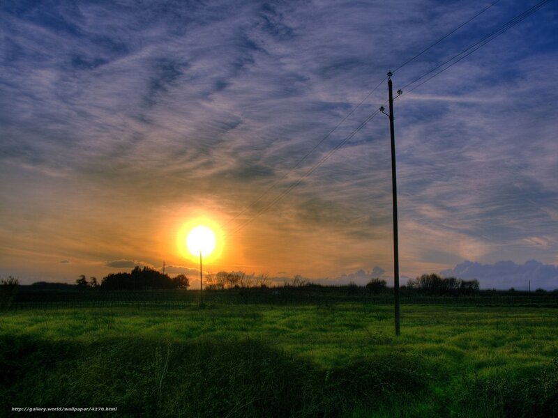 Sunset over a green field