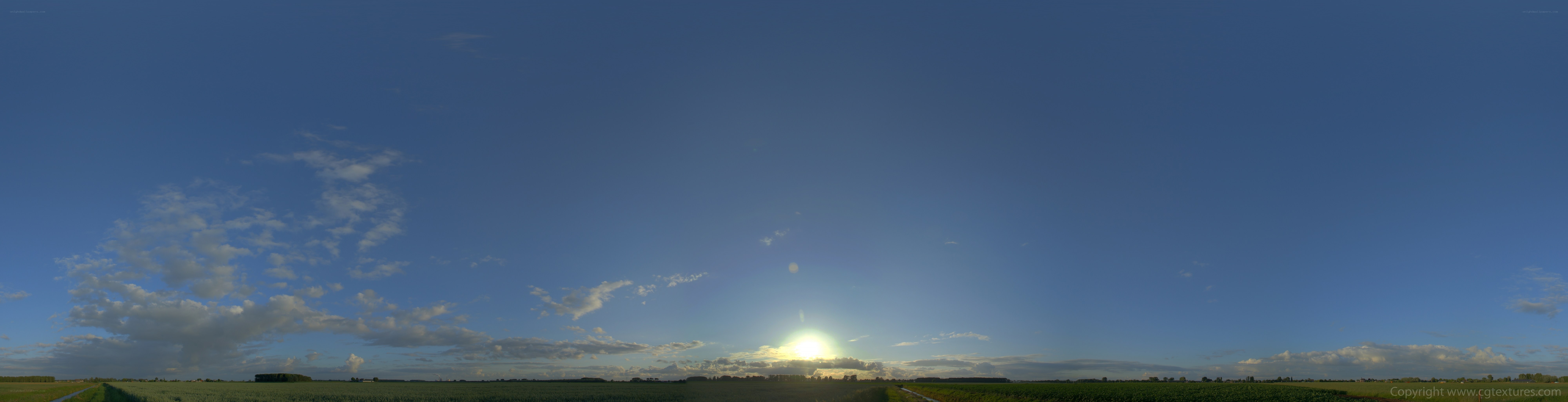Sunset over a green field