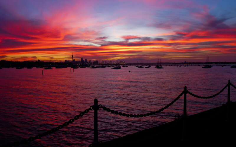 sunset over a harbor city