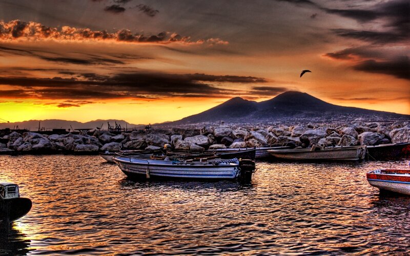 Sunset over a harbor with boats