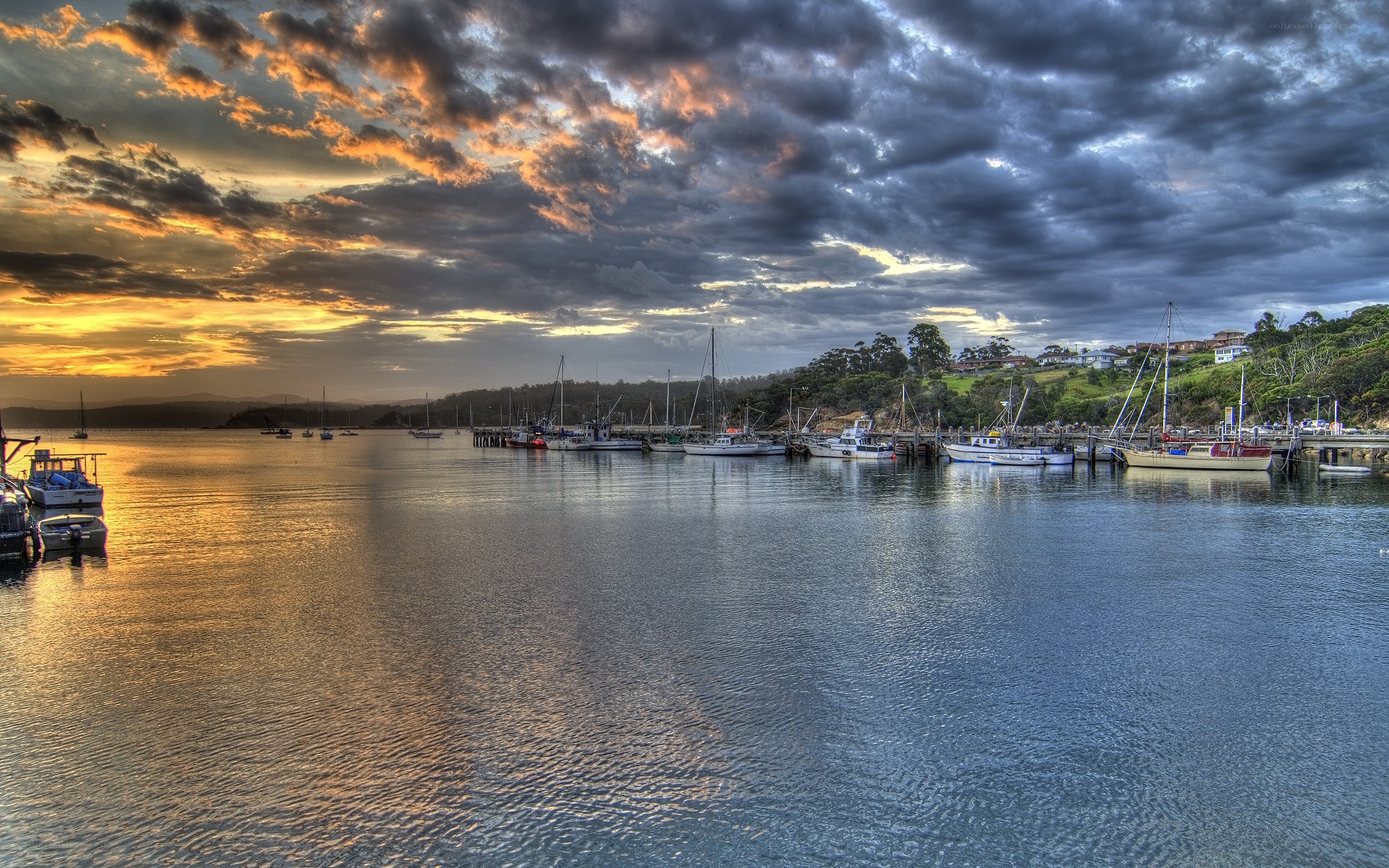 Sunset over a harbor with boats