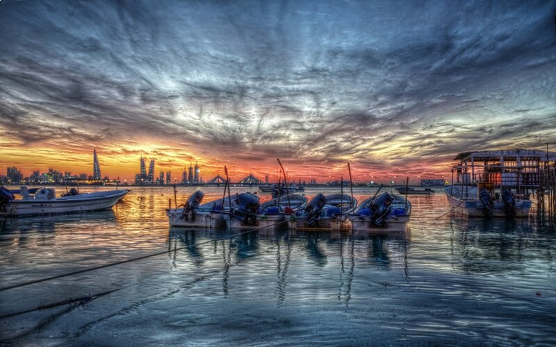 Sunset over a harbor with boats