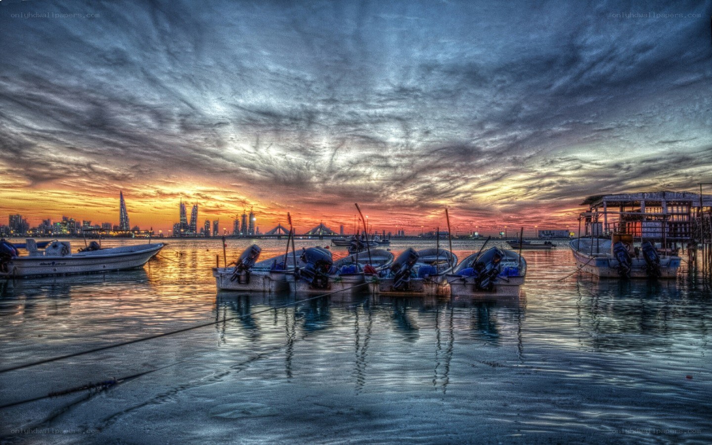 Sunset over a harbor with boats