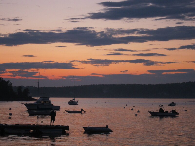 sunset over a harbor with boats