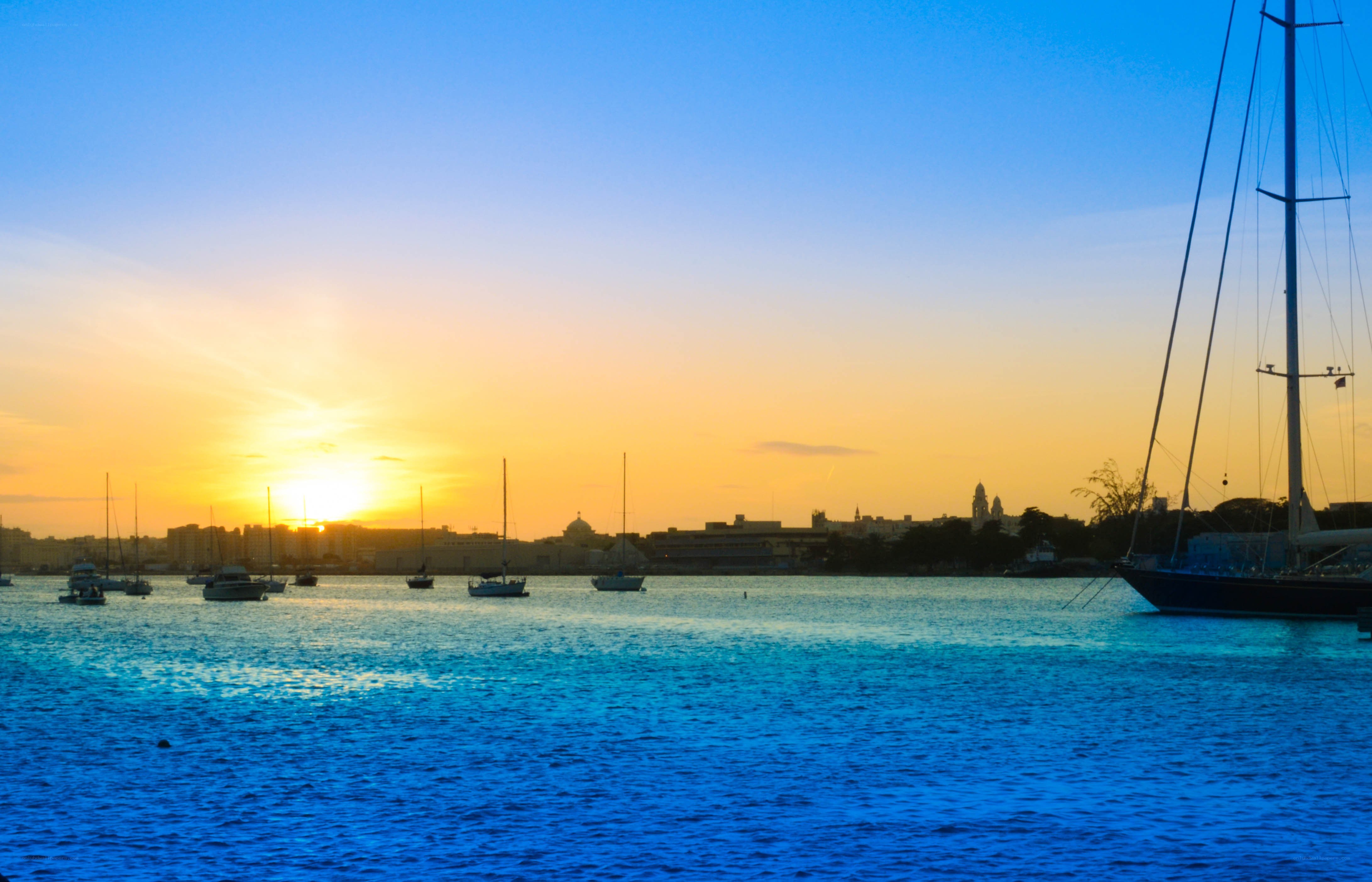 sunset over a harbor with boats