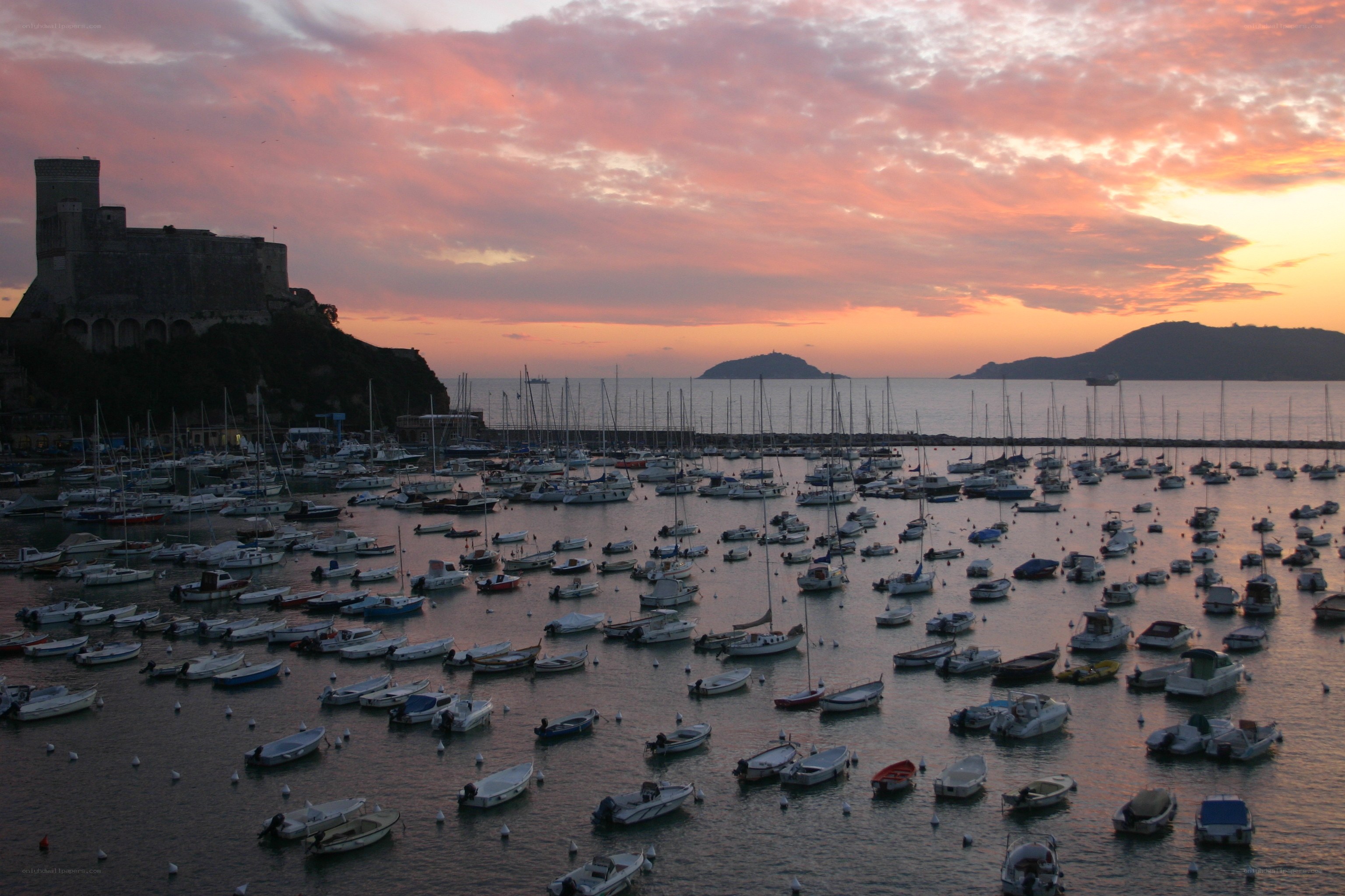 Sunset over a harbor with boats