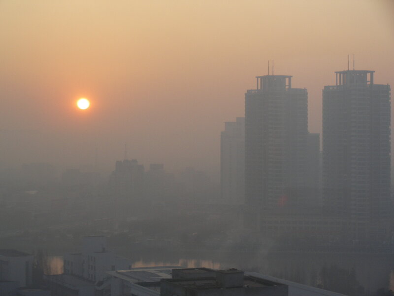 Sunset over a hazy city