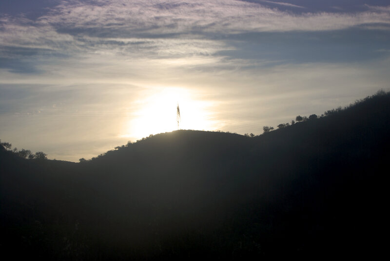 Sunset over a hill with a tower