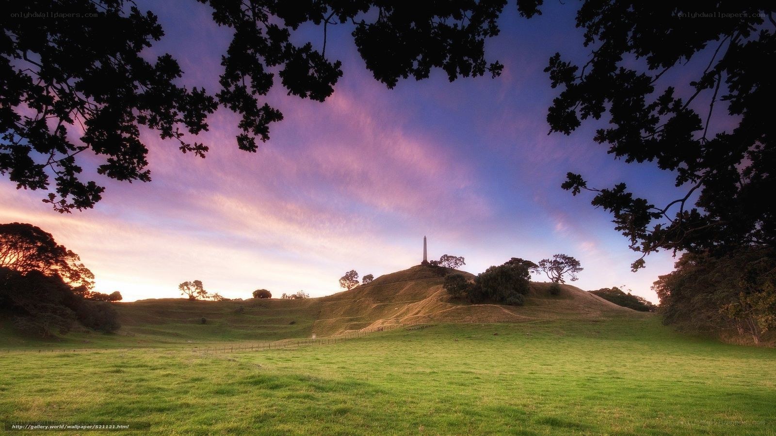 Sunset over a hill with obelisk