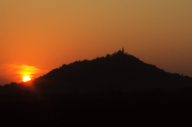 Sunset over a hill with temple