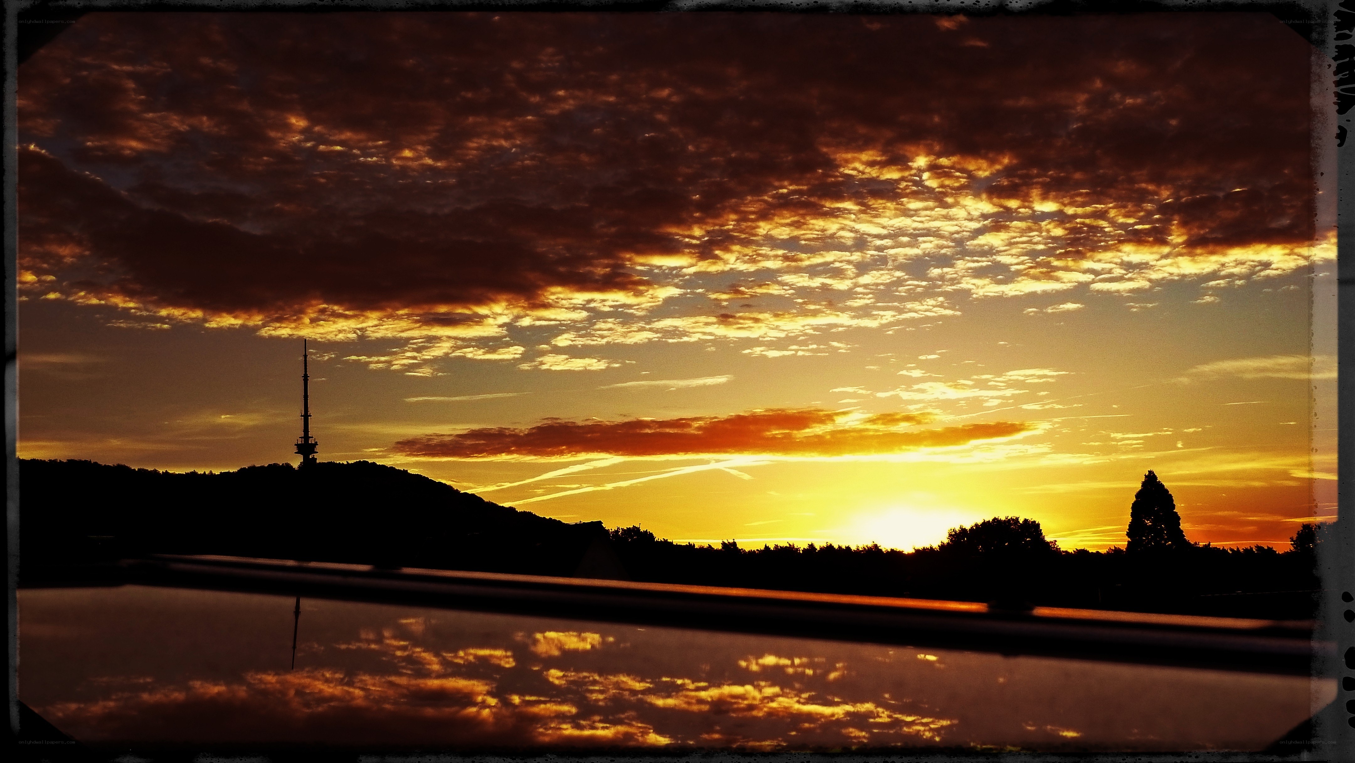 Sunset over a hill with tower