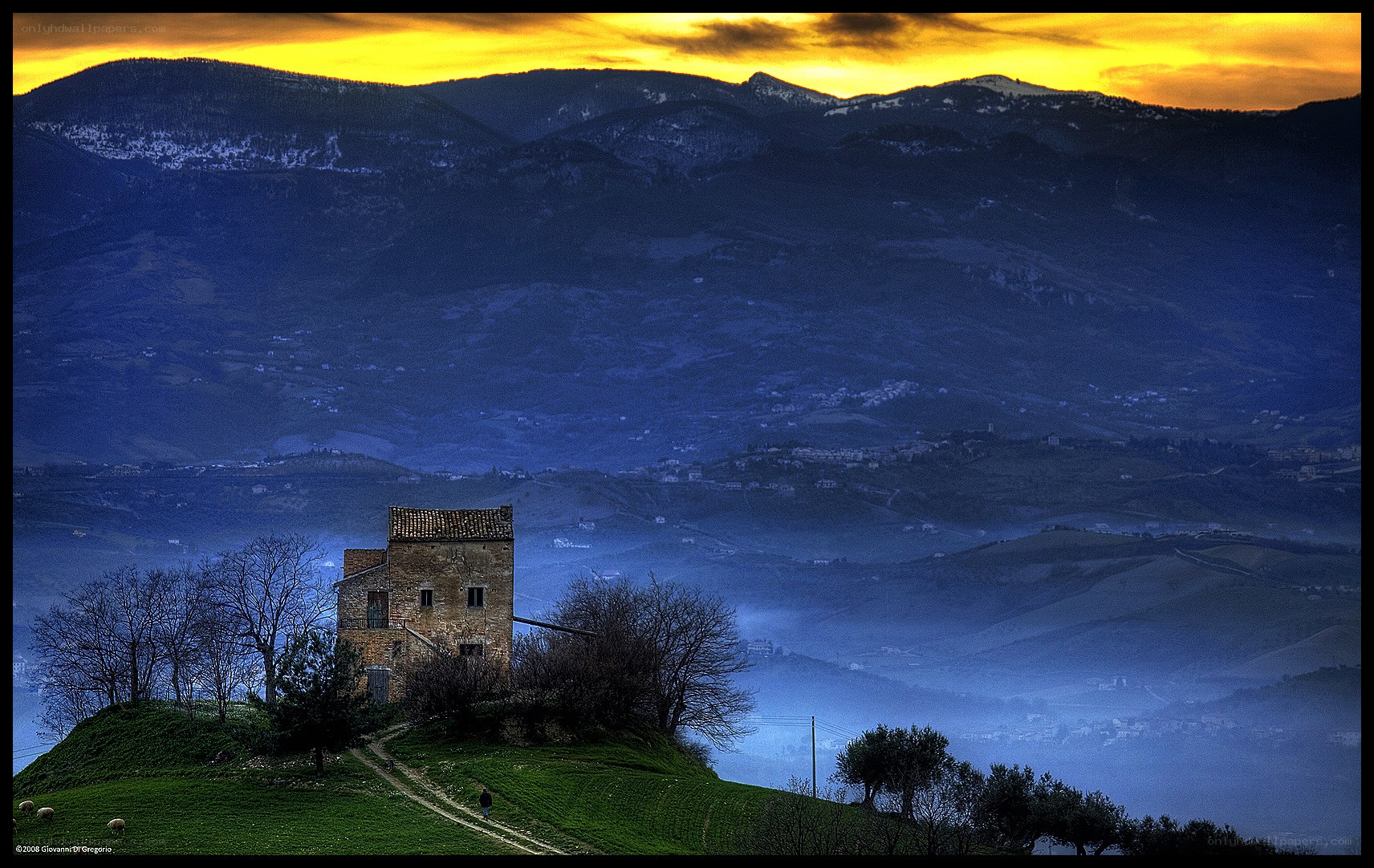 Sunset over a hilltop house