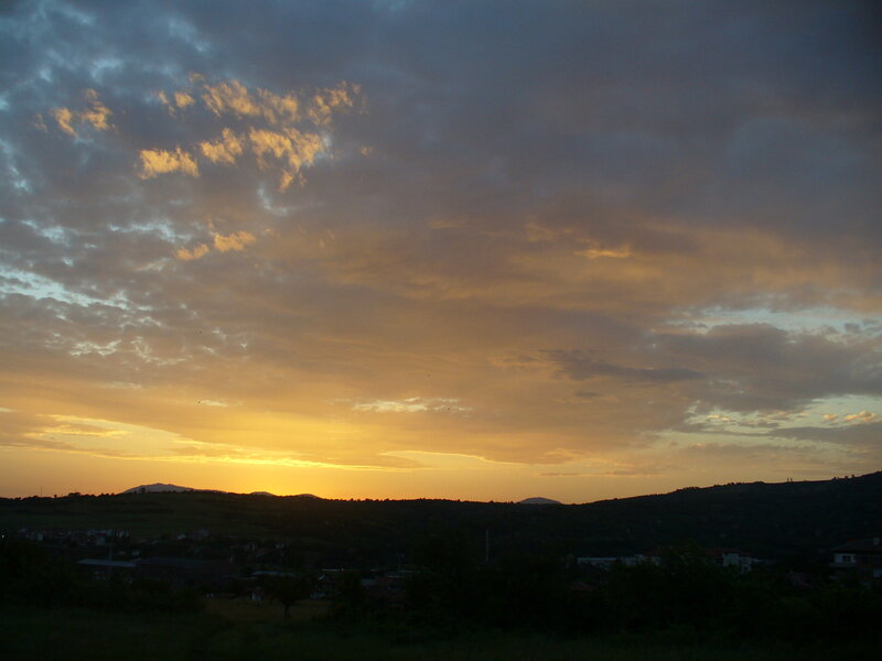 Sunset over a hilly town