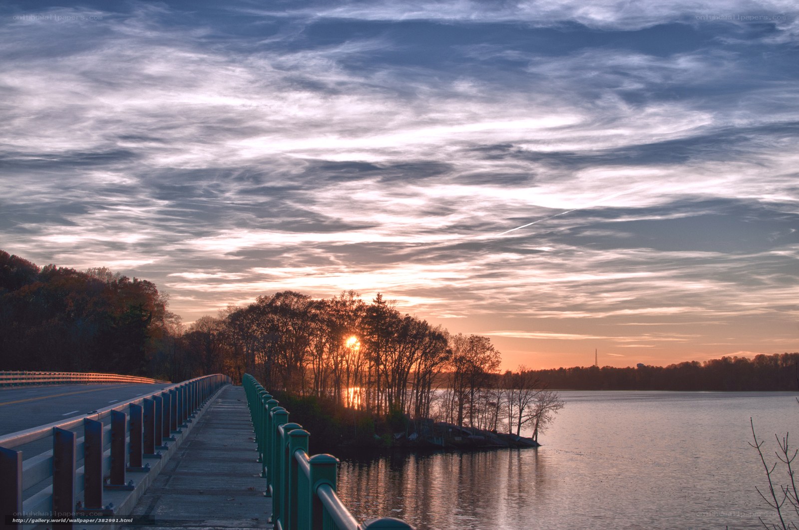 Sunset over a lake and bridge
