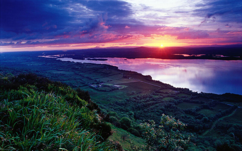 sunset over a lake and fields