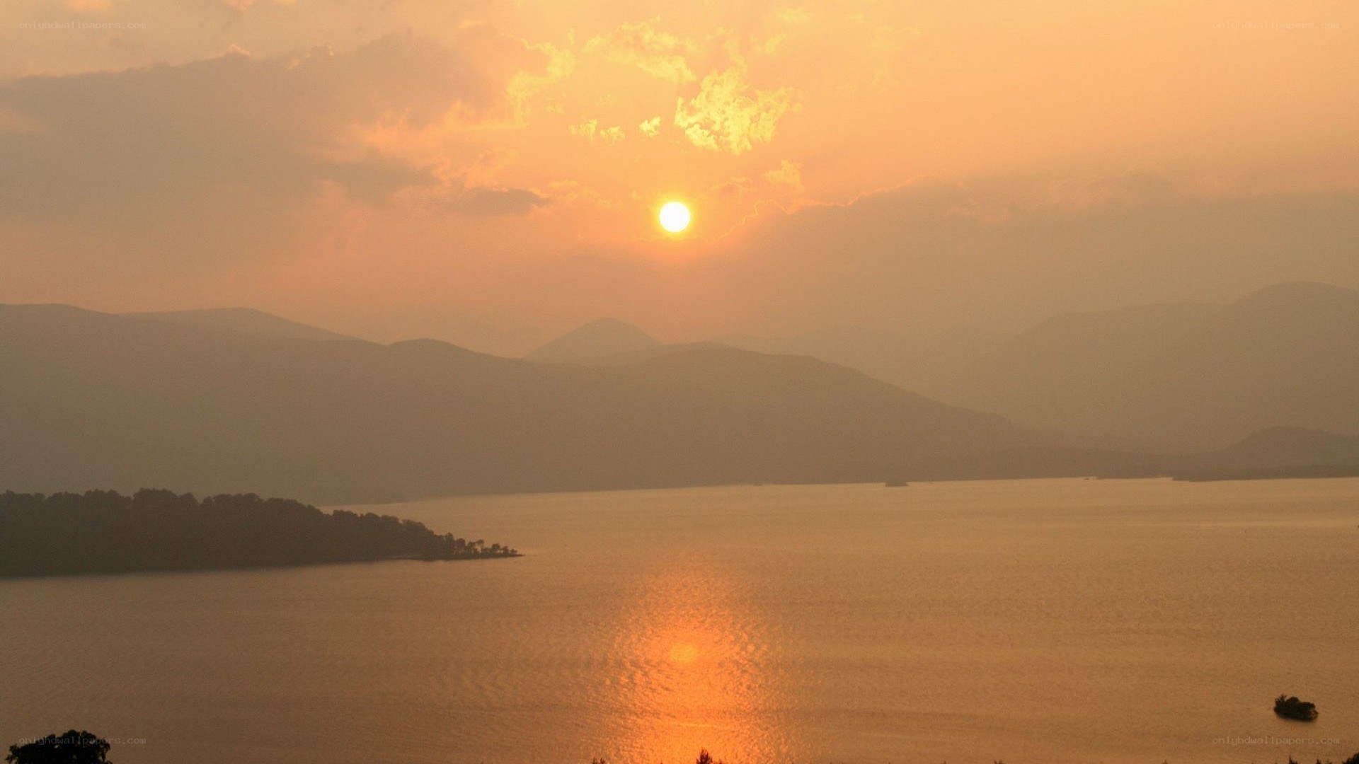 sunset over a lake and mountains