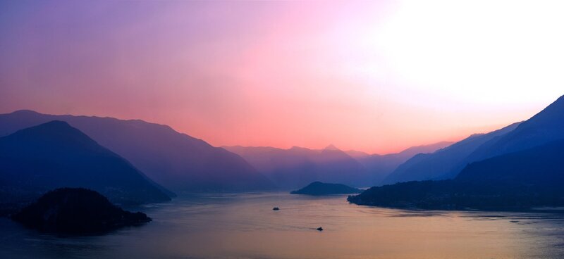 sunset over a lake and mountains