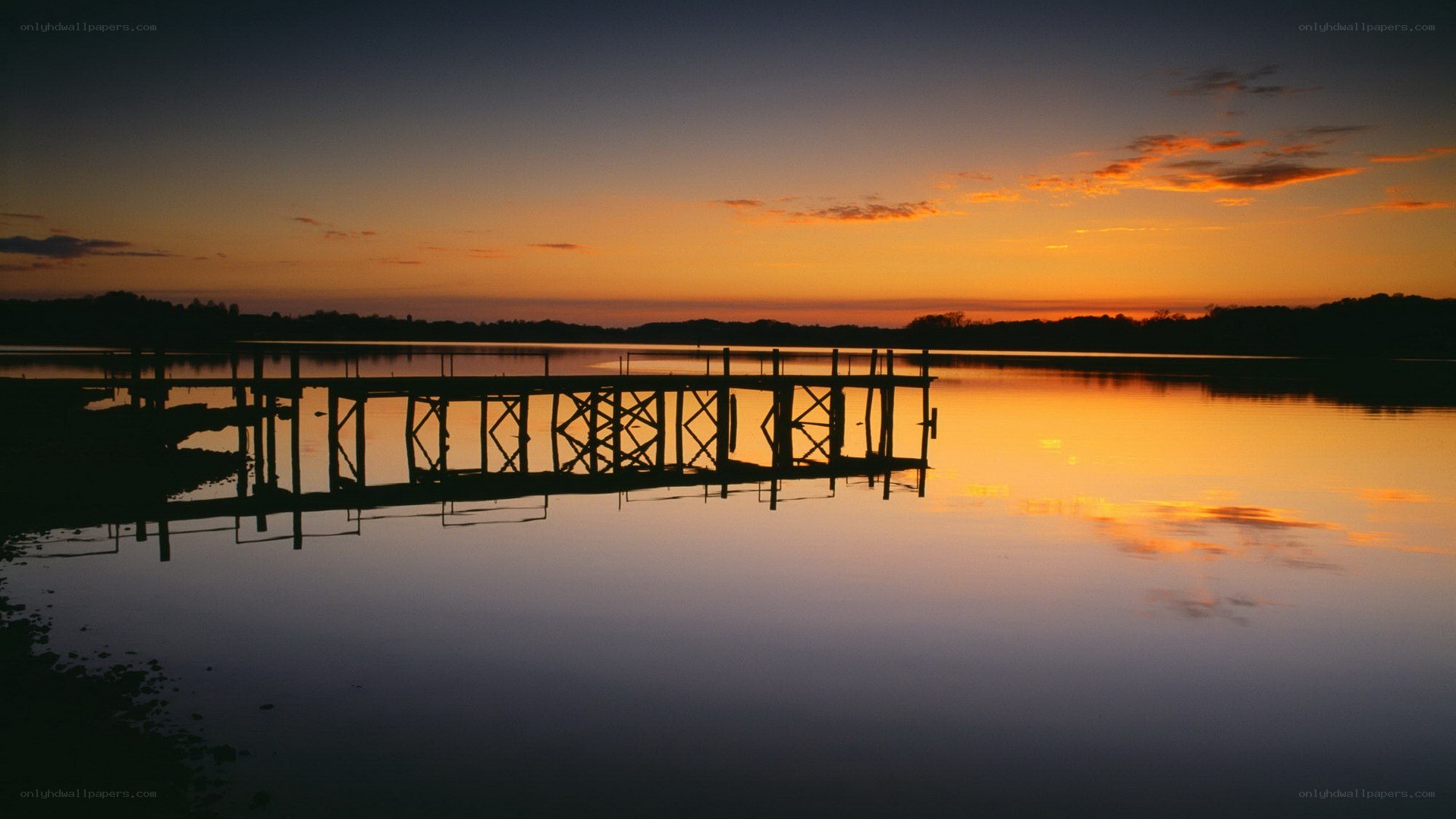 sunset over a lake dock