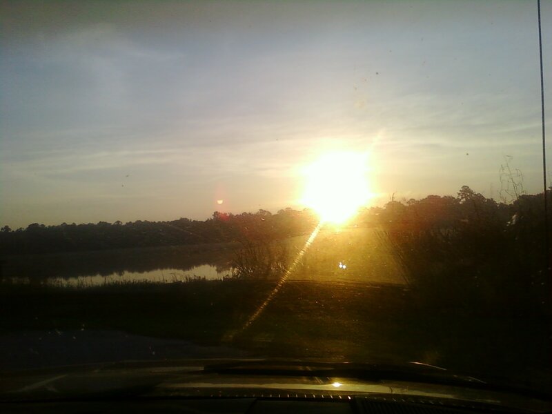 Sunset over a lake from car