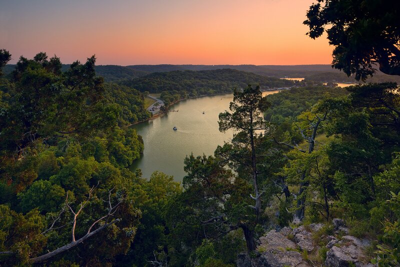 sunset over a lake in the hills
