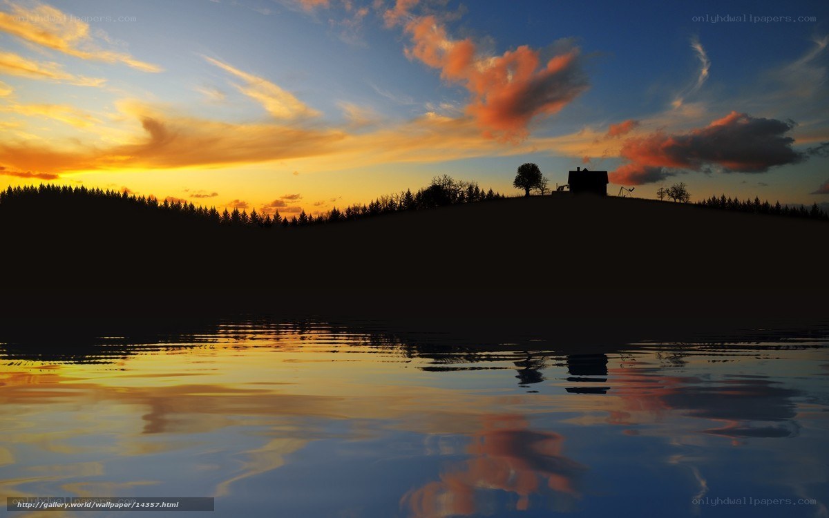 Sunset over a lake with a cabin