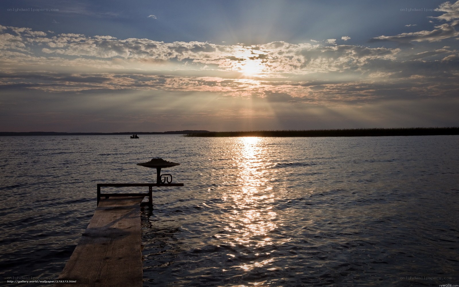 Sunset over a lake with a dock